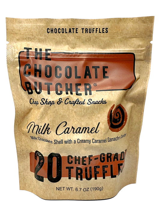 A beige stand-up pouch from The Chocolate Butcher contains 20 Milk Chocolate Caramel Truffles with creamy ganache centers. Packaging highlights the milk chocolate shell and caramel. Net weight: 6.7 oz (190g).