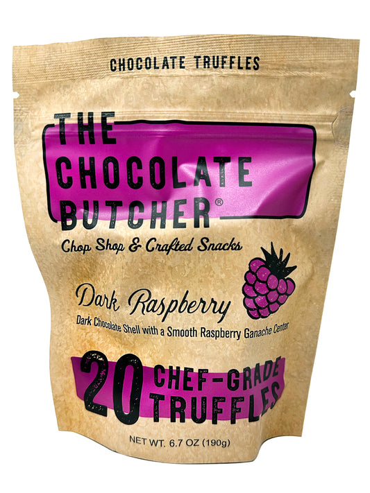 A resealable bag of The Chocolate Butcher Dark Chocolate Raspberry Truffles, featuring a raspberry illustration and bold text highlighting 20 chef-grade truffles with a decadent dark chocolate shell and smooth ganache center.