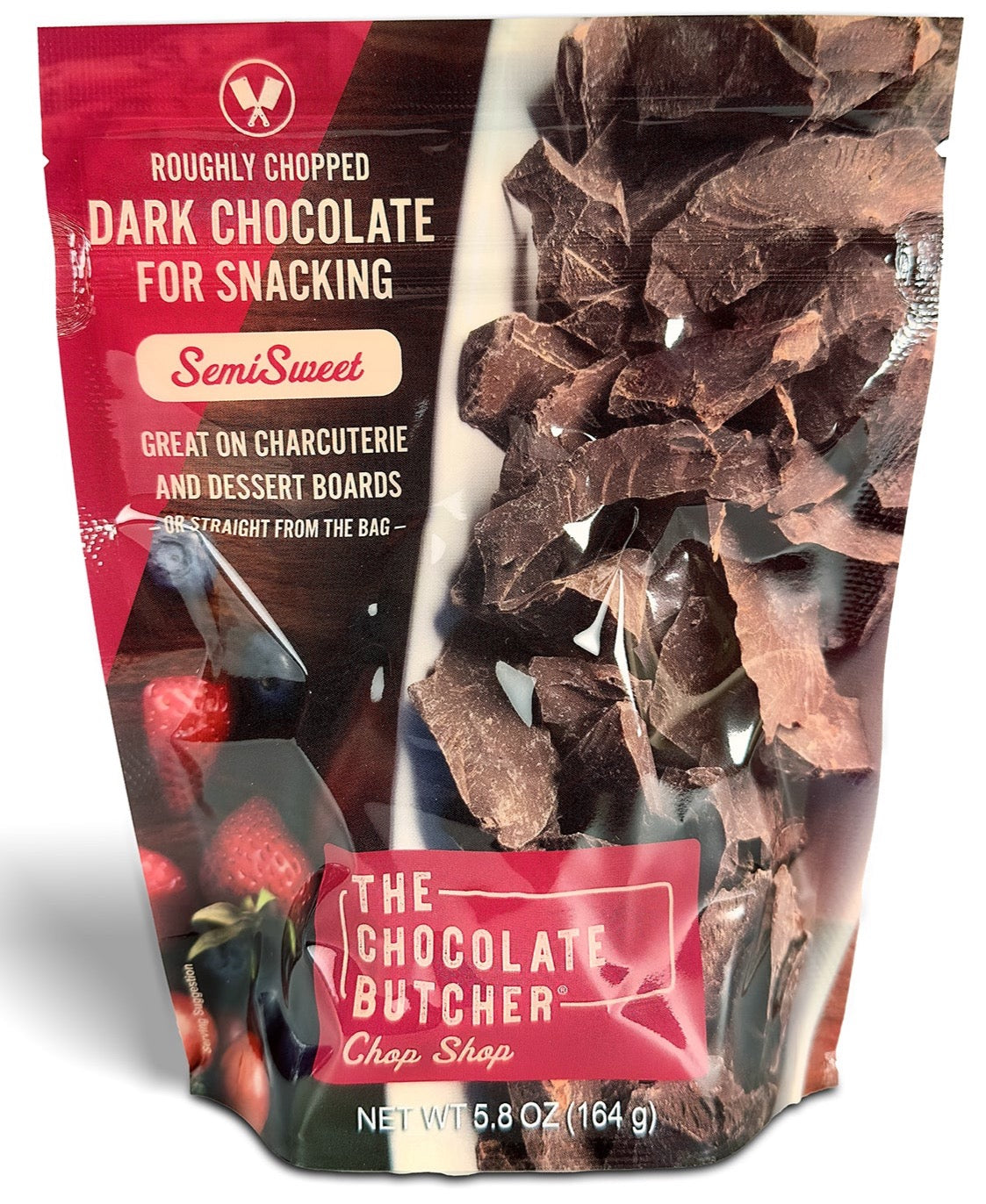 A 5.8 oz (164g) bag of The Chocolate Butcher’s SemiSweet Dark Chocolate — Roughly Chopped, perfect for snacking or dessert boards, with a rich fudge flavor and packaging featuring chocolate pieces and strawberries.