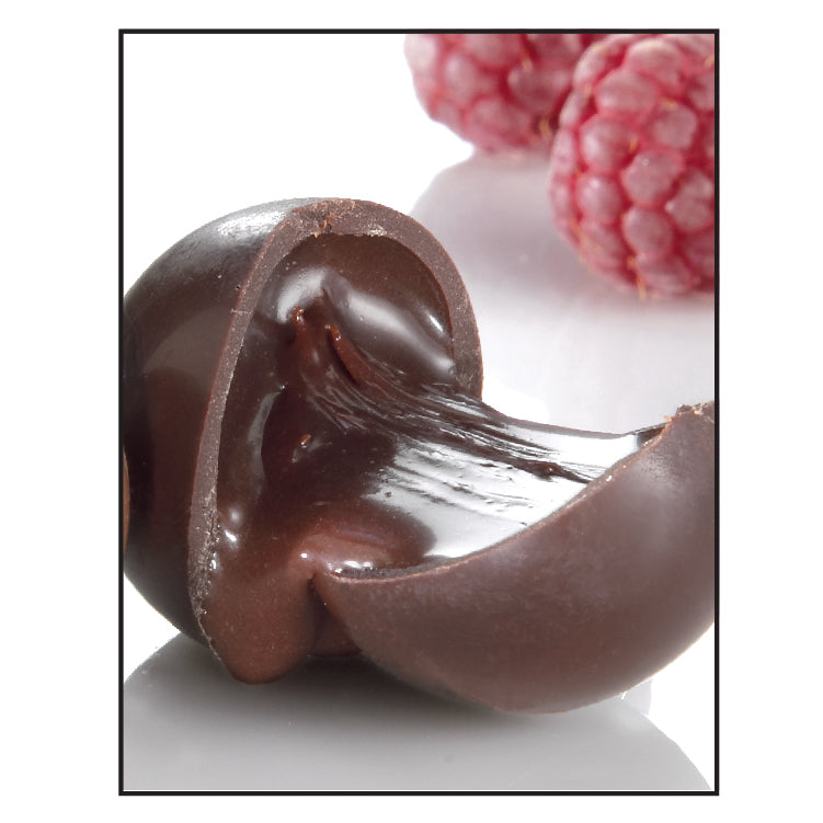 The Chocolate Butcher Chocolate Raspberry Truffles feature a rich ganache center, elegantly displayed with two raspberries in the background—an irresistible treat for dark chocolate or raspberry truffle lovers.
